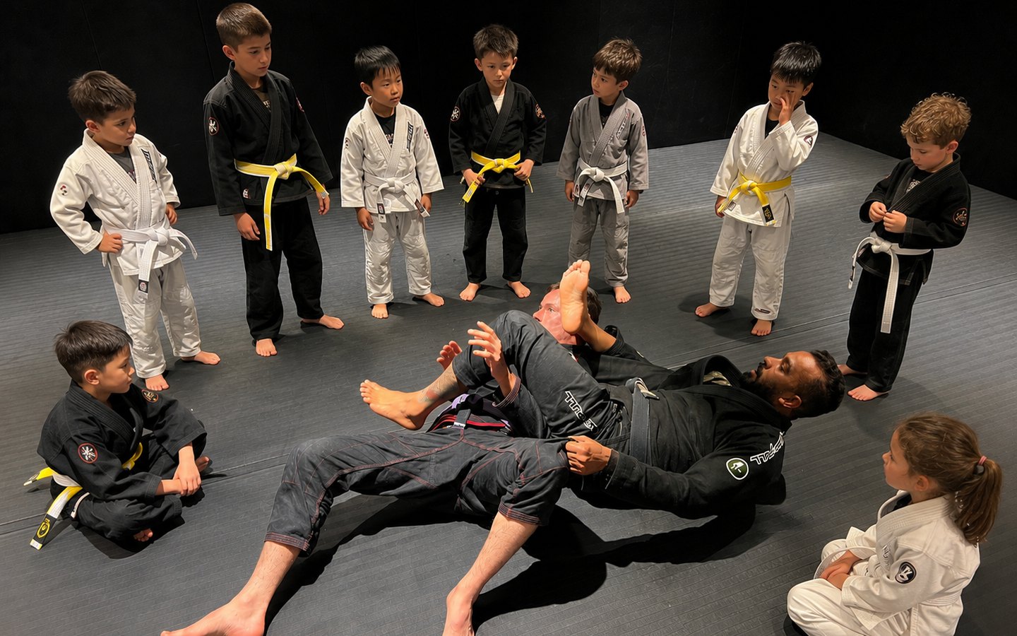 Kids Jiu-Jitsu class at BJJ UNION, coach demonstrating a technique to the group